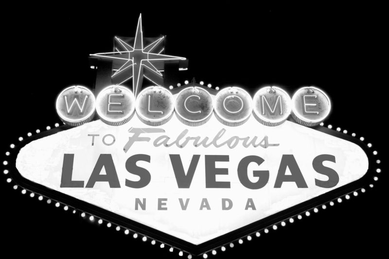 Welcome to Las Vegas sign in bold letters, surrounded by dark sky, evoking a classic Nevada atmosphere.