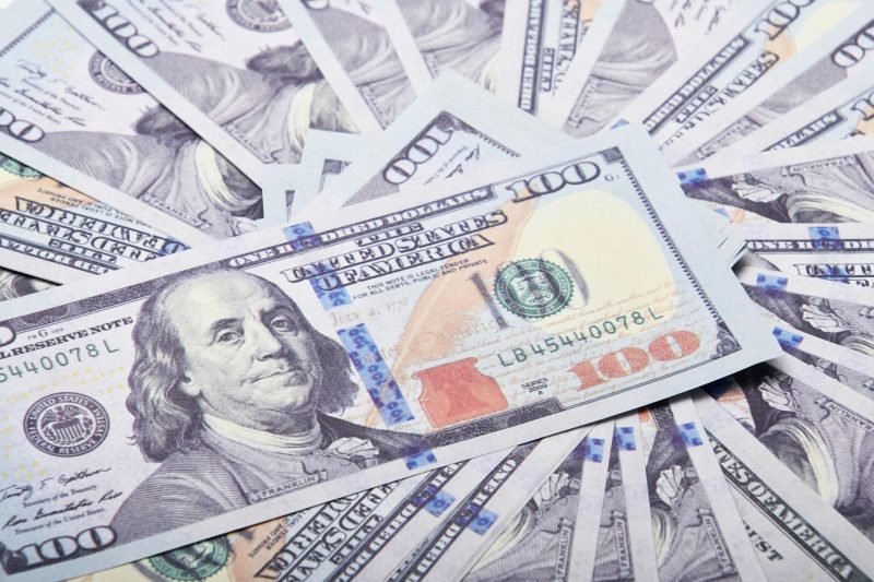 A fan of hundred dollar bills arranged to symbolize wealth and financial success.