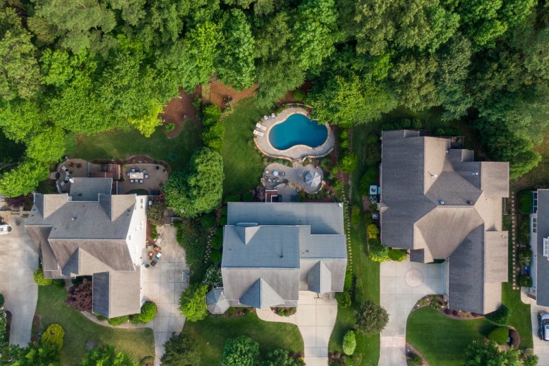 Aerial view of a Wake Forest suburb featuring green backyards and a swimming pool.