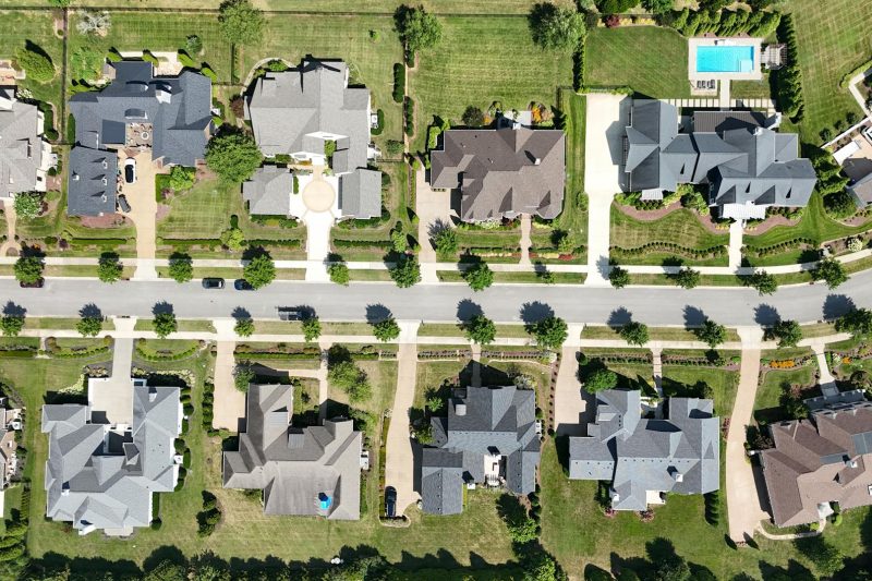 Overhead view of modern homes nestled among lush greenery in a suburban Tennessee neighborhood.